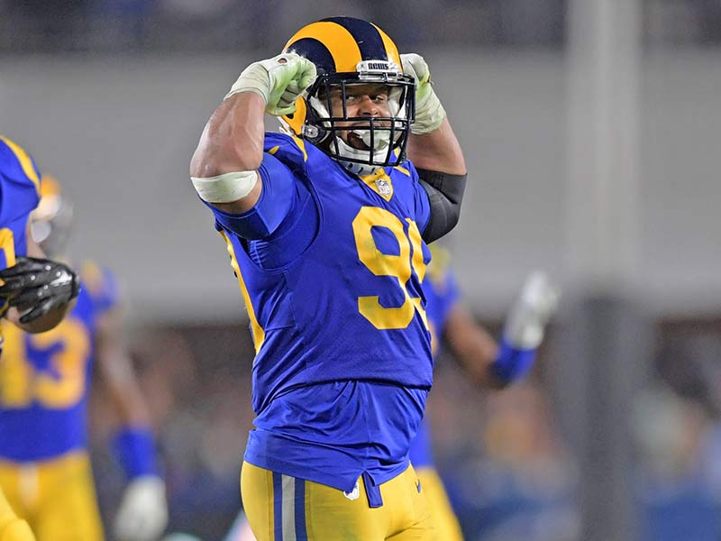 Aaron Donald of Rams flexing his biceps in the field