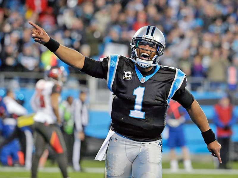 Cam Newton of Jaguars smiling and making number 1 with hand